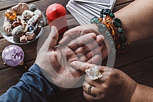 Palmistry concept. Fortune teller reading fortune lines on hand, top view