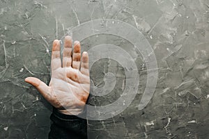 Palmistry concept. Male hand on gray table with open palm, chiromancy lines of fortune, copy space