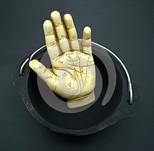 Palmistry hand in cauldron