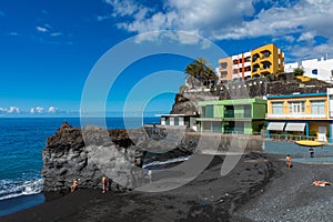 Palms  at beach with black lava sand at Puerto Naos in La Palma Island, Canary Island, Spain