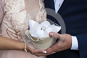 Palms of the bride and groom, hold wedding rings