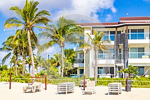 Palms parasols sun loungers beach resort Playa del Carmen Mexico