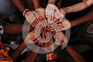 Palms up hands of happy group of multinational African, latin american and european people which stay together in circle