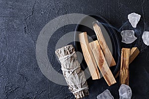 Palo Santo stick burning with aroma smoke, white sage, crystals for meditation esoteric ceremony. Mindfulness and slow living