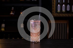 Paloma cocktail on a bar counter in a nightclub.