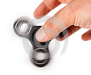 Palying with a Black Fidget Spinner