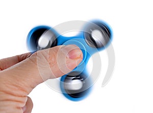 Palying with a blue Fidget Spinner.