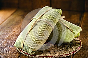 Pamonha, typical corn sweet with rural cheese from Brazil, closed in dry straw, consumed in July and June parties
