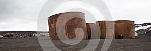 Pamoramic view of old abandoned oil storage tanks at Whaler`s Bay, Deception Island, Antarctica