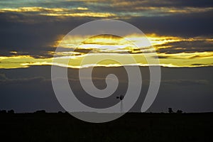 Pampas windmill landscape at sunsetin storm, La Pampa photo
