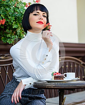 Pamper yourself. Girl relax cafe with cake dessert. Woman attractive elegant brunette eat gourmet cake cafe terrace