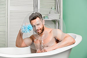 Pampering and beauty routine. Handsome muscular man relaxing bathtub. Warm bath concept. Transform your bathroom into