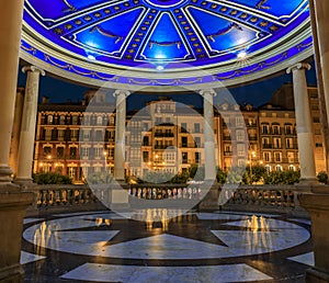 Domed gazebo illuminated at night, Historic Plaza del Castillo in Pamplona Spain