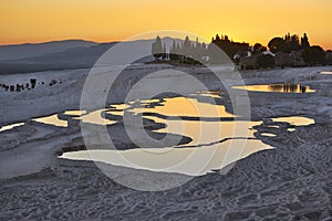 Pamukkale white mineral limestone natural pool at sunset. Turkey