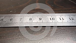 pan along a metal ruler.
