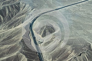 The Pan-American Highway next to a spiral geoglyph, Nazca Lines, Peru