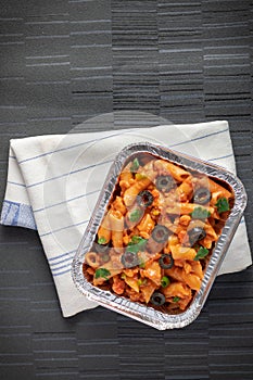 Pan arrabiata penne pasta in a foil box