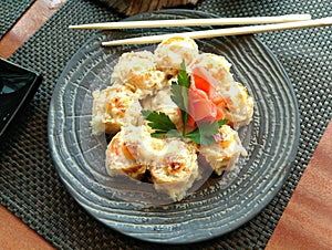 Pan-Asian rolls on a blue plate on the table
