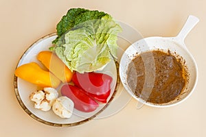 Pan of bagna cauda with a dish of vegetables as trimming photo