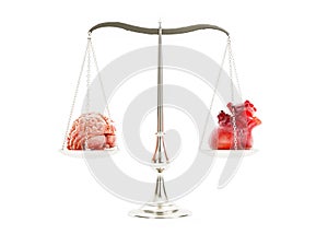 Pan balance with human brain and human heart placed on opposite scale pans