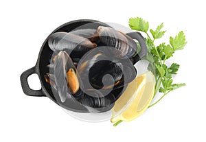 Pan of cooked mussels with parsley and lemon on white background, top view