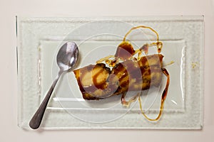 Pan de Calatrava with caramel and spoon, spanish pudding cake photo