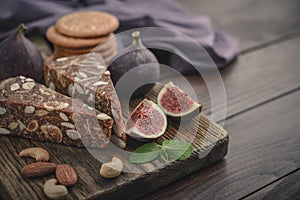 Pan de Higo - Spanish fig bread at wooden cutting board photo