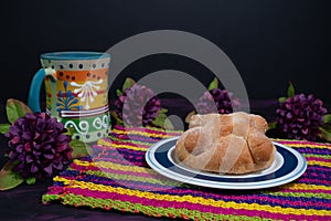 Pan de Muerto, Bread of Dead Mexican Sugar Scone on Woven Tablecloth. photo