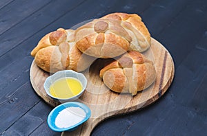 Pan de muerto on wooden board on dark background. Copy space. Day of the dead. Mexican holiday. Mexican food