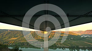 Pan down underside of the Moseltal bridge near Koblenz Germany during sunrise