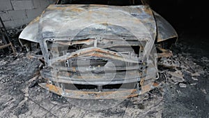 Pan footage of burned out car in garage