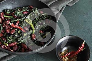 Pan - fried black cabbage, red beans, chili and bread.