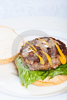 Pan fried burger with mustard and sesame dressings photo