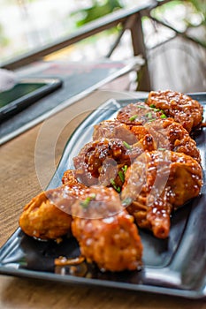 Pan fried chicken Momo served in a black plate over moody background. Selective focus