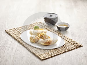 Pan-fried Chilli Crab Dumpling with sauce served in a dish isolated on mat side view on grey background