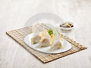 Pan-fried Crispy Pork Dumpling with sauce served in a dish isolated on mat side view on grey background