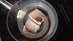 Pan-fried fish, Two pieces of loban fillet on the steaming frying pan.