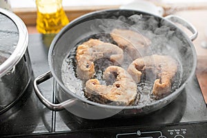 Pan with frying sturgeon fish. Outdoor kitchen. Summer barbeque and vacation