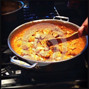 Pan of Indian butter chicken photo