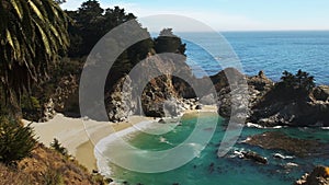 Pan of McWay falls along the California coast in big sur