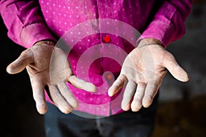 Pan shot close up of daily wager or construction labour rough hands - concept of hardworking and overworked