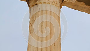 Pan shot of tall marble column with sophisticated capital, Ionic architecture