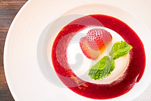 Panacotta with fresh strawberry and sauce photo