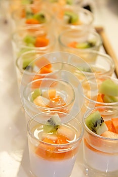 Panacotta with mixed fresh fruit in glass photo