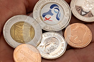 Panama money, Balboa coins lying on an outstretched hand, Financial concept