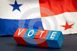 Panama vote, Word Vote on wooden blocks against the background of the Panamanian flag, the concept of voting and taking part in