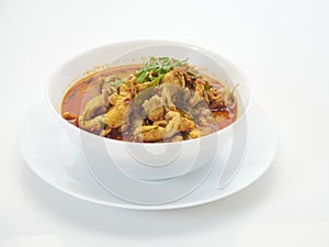 Panang chicken curry in white bowl