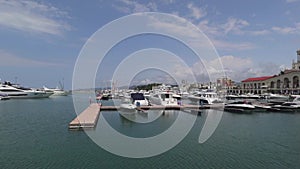 Panarama of luxury yachts docked in sea port at summertime.