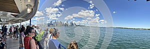 Panaramic View of Crowd looking at Toront skyline on the Toronto Island Ferry