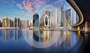 Panaroma of Dubai skyline with Burj khalifa and other skyscrapers at night from Al Jadaf Waterfront UAE